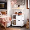 A kitchen scene with a rolling cart filled with food items and decor. Náhled obrázku produktu