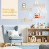 A nursery or child's room setting with shelves, a chair, and toys. Náhľad obrázku produktu