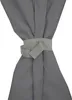 A close-up view of a gray fabric tie holding together draped fabric. Anteprima dell’immagine prodotto