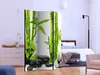 A room divider with a bamboo and stone design is placed in a bedroom setting. Podgląd zdjęcia produktu