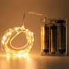 A close-up shot of a string of warm white LED lights with a battery pack. Produktbild-Vorschau