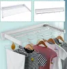Collage of images showing a white foldable clothes drying rack mounted on a wall, with clothes hanging on it. Produktbild-Vorschau