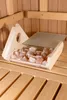 A wooden box filled with pink salt crystals inside a wooden sauna. Produktbild-Vorschau