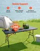 A folding table set up outdoors with drinks and fruit on it, near a tent. Produktbild-Vorschau