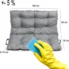 A hand in a yellow glove is cleaning a gray cushion with a blue sponge. Dimensions are shown on the image. Produktbild-Vorschau
