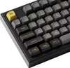 A close-up view of a black mechanical keyboard with yellow and gray keycaps. Produktbild-Vorschau