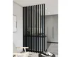 A modern interior with a black slatted room divider separating living and kitchen areas. Náhled obrázku produktu