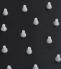 A collection of small, white, cone-shaped objects arranged in a grid pattern on a black background. Anteprima dell’immagine prodotto
