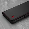 A black leather phone case with red stitching and a red bull logo is shown on a gray textured surface. Anteprima dell’immagine prodotto
