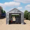 A gray tent garage on a construction site with a truck and building materials. Produktbild-Vorschau