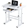 A white adjustable height desk with a laptop, books, and art supplies on it. Podgląd zdjęcia produktu