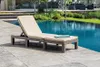 A lounge chair next to a swimming pool. Voir les images du produit