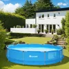 A round blue swimming pool is set up on a green lawn in front of a modern white house with a black roof. Náhled obrázku produktu