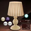 A table lamp with a pleated shade is shown against a dark background, with several circular icons and text boxes providing product information. Produktbild-Vorschau
