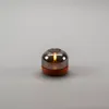 A battery-operated LED candle with a smoky glass shade and a terracotta-colored base is displayed on a plain gray background. Produktbild-Vorschau