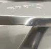 A close-up shot of the edge of a silver ironing board. Podgląd zdjęcia produktu