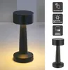 A black rechargeable table lamp with touch function and adjustable brightness, shown on a light gray and white background, with feature icons on the right. Produktbild-Vorschau