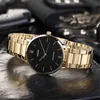 A close-up shot of a gold Casio watch with a black face, resting on a dark, textured surface. Produktbild-Vorschau