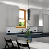 A modern kitchen interior with a dining table and chairs in the foreground, and kitchen cabinets and a window in the background. Produktbild-Vorschau
