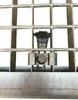 A close-up view of a metal grate with a fastening mechanism. Produktbild-Vorschau