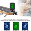 A close-up of a guitar tuner attached to a guitar, with a woman playing a guitar in the background, and three examples of the tuner's display. Náhled obrázku produktu