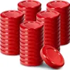 Several stacks of red lids for canning jars are arranged on a white background, with one lid lying on its side in the foreground. Podgląd zdjęcia produktu