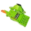 A green and orange vegetable slicer is shown against a white background. Voir les images du produit