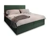 A green upholstered bed with pillows and a blanket. Produktbild-Vorschau