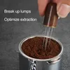 A hand holding a coffee distributor tool over a portafilter filled with coffee grounds. Produktbild-Vorschau