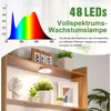 A shelf with plants and a grow light. Produktbild-Vorschau