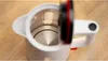 A close-up, top-down view of the inside of a white electric kettle with its lid open. Voir les images du produit