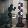 A woman is training with a punching bag in a gym. Produktbild-Vorschau