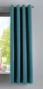 A teal curtain hangs in front of a window, with a glimpse of greenery outside.