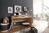 A home office setup with a wooden desk, laptop, and decorative items. Anteprima dell’immagine prodotto