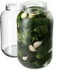 Two glass jars, one filled with pickles and spices, the other empty. Podgląd zdjęcia produktu