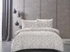 A bed with floral patterned bedding in a room setting. Náhled obrázku produktu
