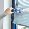 A hand is cleaning window blinds with a specialized cleaning tool. Produktbild-Vorschau