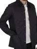 A man wearing a blue quilted jacket. Produktbild-Vorschau