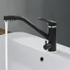 A black kitchen faucet with water running into a white sink. Produktbild-Vorschau