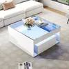 A modern living room with a white sectional sofa and a white coffee table with blue LED lighting. Voir les images du produit