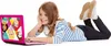 A young girl is lying on the floor, smiling and using a pink laptop. Produktbild-Vorschau