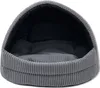 A gray, corduroy dog bed with a hooded opening, shown from the front. Anteprima dell’immagine prodotto