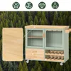 A kitchen island with glass doors and drawers is shown against a backdrop of a forest. Anteprima dell’immagine prodotto