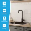 A modern kitchen sink with a black faucet, set against a tiled backsplash and wooden countertop. The left side of the image features a blue overlay with icons and text highlighting product features. Produktbild-Vorschau