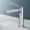 A chrome faucet is shown on a white sink with a marble countertop. Podgląd zdjęcia produktu