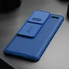 A blue phone case with a sliding camera cover is shown on a gray surface. Podgląd zdjęcia produktu