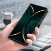 A hand holding a phone case with a green and gold abstract design, with a coffee cup and books in the background. Produktbild-Vorschau