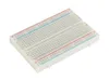 A white breadboard with a grid of holes and colored power rails. Anteprima dell’immagine prodotto
