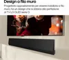 A TV mounted on a wall with a soundbar below it, and a person playing a guitar on the TV screen. Produktbild-Vorschau