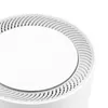 A close-up view of the top of a white electronic device, showing a circular vent pattern. Produktbild-Vorschau
